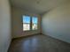 Bright, empty bedroom with tile floors and two windows at 2010 Divot Dr, Daytona Beach, FL 32124