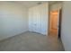 Bright, empty bedroom with tile floors and a double-door closet at 2010 Divot Dr, Daytona Beach, FL 32124
