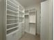 Walk-in closet with custom shelving and tile floors at 2010 Divot Dr, Daytona Beach, FL 32124