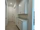 This hallway features built-in shelving, tile floors and white doors at 2010 Divot Dr, Daytona Beach, FL 32124