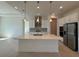 A bright kitchen features a large island, stainless appliances and neutral backsplash at 2010 Divot Dr, Daytona Beach, FL 32124