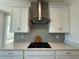 Kitchen featuring stainless vent hood and modern cooktop at 2010 Divot Dr, Daytona Beach, FL 32124