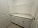 The laundry room features storage cabinets, countertop and utility sink at 2010 Divot Dr, Daytona Beach, FL 32124
