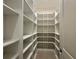 Walk-in pantry features custom shelving and tile floor at 2010 Divot Dr, Daytona Beach, FL 32124