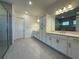 Bathroom with double vanity, storage, and a glass enclosed shower at 2013 Divot Dr, Daytona Beach, FL 32124
