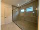 Modern bathroom featuring a spacious glass-enclosed shower with tile and a built-in bench at 2013 Divot Dr, Daytona Beach, FL 32124