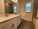 Modern bathroom featuring a double vanity, tile floors, and a framed mirror at 2013 Divot Dr, Daytona Beach, FL 32124