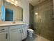 Light-filled bathroom with glass shower, large mirror, and quartz countertops at 2013 Divot Dr, Daytona Beach, FL 32124