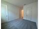 Neutral bedroom with carpet flooring and white doors and trim at 2013 Divot Dr, Daytona Beach, FL 32124