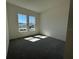 A carpeted room featuring two windows with views to the front of the home at 2013 Divot Dr, Daytona Beach, FL 32124