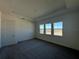 Bedroom with three large windows with a view of a pond at 2013 Divot Dr, Daytona Beach, FL 32124