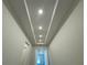 Entry hallway featuring a tray ceiling, recessed lighting and views to other rooms at 2013 Divot Dr, Daytona Beach, FL 32124