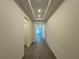 Entry hallway featuring tray ceiling, recessed lighting and wood look tile floors at 2013 Divot Dr, Daytona Beach, FL 32124