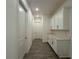 Hallway featuring tile floors and white cabinetry with a white countertop at 2013 Divot Dr, Daytona Beach, FL 32124