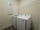 Bright laundry room featuring Samsung washer and dryer, plus overhead wire rack at 2013 Divot Dr, Daytona Beach, FL 32124