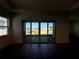 Bright living room with hardwood floors and sliding doors leading to the backyard at 2013 Divot Dr, Daytona Beach, FL 32124