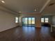 Large living room with tile flooring, windows with water views, and sliding door at 2013 Divot Dr, Daytona Beach, FL 32124
