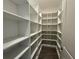 Walk-in pantry with ample shelving and hardwood floors at 2013 Divot Dr, Daytona Beach, FL 32124