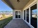 Covered patio with brick flooring, offering a view of the community at 2013 Divot Dr, Daytona Beach, FL 32124