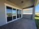 Covered patio with brick flooring, providing a relaxing outdoor space at 2013 Divot Dr, Daytona Beach, FL 32124