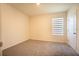 Neutral bedroom with blinds, gray carpet, and natural light at 2464 Ribbon Fall Ave, Davenport, FL 33837