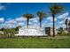 Cascades community entrance sign surrounded by lush landscaping and palm trees on a sunny day at 2464 Ribbon Fall Ave, Davenport, FL 33837