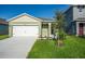 Inviting single-Gathering home with a two-car garage and freshly landscaped front yard at 2464 Ribbon Fall Ave, Davenport, FL 33837