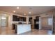 Open-concept kitchen featuring stainless steel appliances, center island, and dark cabinetry at 2464 Ribbon Fall Ave, Davenport, FL 33837