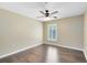 This bedroom features a ceiling fan and a window with wood-look flooring at 25249 Derby Dr, Sorrento, FL 32776