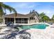 Back exterior view of pool with outdoor seating and palm trees at 25249 Derby Dr, Sorrento, FL 32776