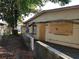View of the side of the house showing a retaining wall and boarded up windows at 2652 Ravenall Ave, Orlando, FL 32811