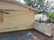 Exterior view of the side of the house with a concrete block retaining wall at 2652 Ravenall Ave, Orlando, FL 32811