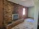 Living room features a brick fireplace and a large window at 2652 Ravenall Ave, Orlando, FL 32811