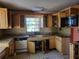 Picture of the kitchen with wooden cabinets, tile backsplash, and a stainless steel faucet at 2652 Ravenall Ave, Orlando, FL 32811