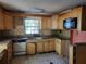 Picture of the kitchen with wooden cabinets, tile backsplash, stainless steel faucet, and appliances at 2652 Ravenall Ave, Orlando, FL 32811