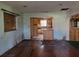 View of the living room that leads into the kitchen area that features wood cabinets and tile backsplash at 2652 Ravenall Ave, Orlando, FL 32811