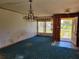 Spacious living room with large window, chandelier and wood paneling at 2652 Ravenall Ave, Orlando, FL 32811