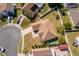 Aerial view of home featuring well-maintained roof, driveway, and spacious yard with mature trees in neighborhood at 2712 Pearl Court, Kissimmee, FL 34743