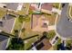 Aerial view showcases a well-maintained property with lush lawn and mature trees in a residential neighborhood at 2712 Pearl Court, Kissimmee, FL 34743
