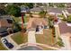 Aerial view of a house with well-manicured landscaping, driveway, and a neatly outlined property boundary at 2712 Pearl Court, Kissimmee, FL 34743