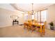 Bright dining room with a wooden table set, neutral carpet, and large window offering lots of natural light at 2712 Pearl Court, Kissimmee, FL 34743