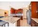 Open concept kitchen provides granite counters, tile backsplash, stainless appliances and breakfast bar with stool seating at 2712 Pearl Court, Kissimmee, FL 34743