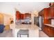 Open kitchen offers granite countertops, stainless appliances, tile backsplash, and a convenient breakfast bar seating area at 2712 Pearl Court, Kissimmee, FL 34743