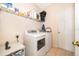 Functional laundry room with modern washer and dryer, convenient shelving, and easy access to the outdoors at 2712 Pearl Court, Kissimmee, FL 34743