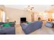 Bright living room with neutral carpet, comfortable sofas, and seamless access to the entryway at 2712 Pearl Court, Kissimmee, FL 34743