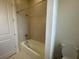 Neutral-colored tiled shower and tub combination with white fixtures at 2861 Willowseed Ln, St Cloud, FL 34772