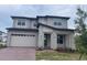 Stunning two-story home with a brick driveway, attached garage, and well-manicured lawn at 2861 Willowseed Ln, St Cloud, FL 34772