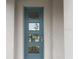 Contemporary teal front door with modern glass panes offering natural light and curb appeal at 2861 Willowseed Ln, St Cloud, FL 34772