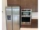 Stainless steel Samsung appliances and dark wood cabinetry in this well-appointed kitchen at 2861 Willowseed Ln, St Cloud, FL 34772