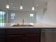 Island with stainless steel dishwasher and pendant lighting at 2861 Willowseed Ln, St Cloud, FL 34772